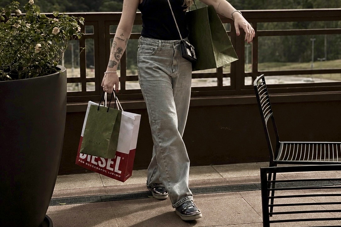 Ana carrying Diesel and Gucci shopping bags